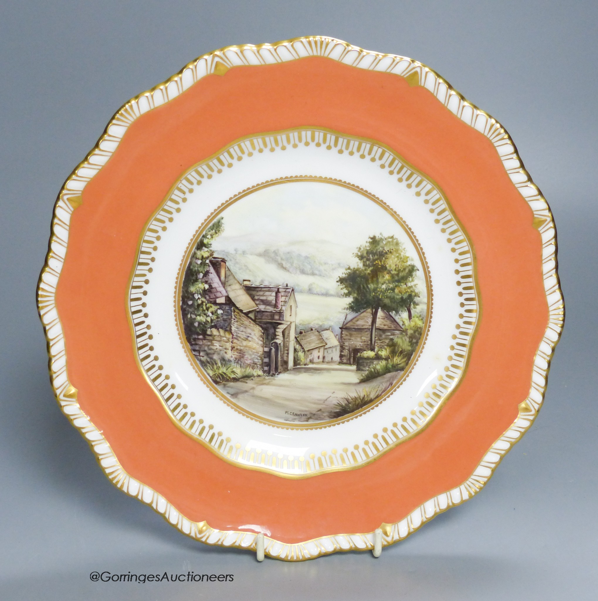 A Royal Crown Derby plate painted with a view of Stoney Middleton, Derbyshire under a burnt orange