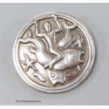 A Georg Jensen sterling circular brooch, design no. 285, depicting a man with two fish, 42mm.