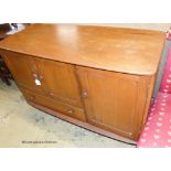 An Ercol Windsor elm three door sideboard W-114, D-51, H-81cm.