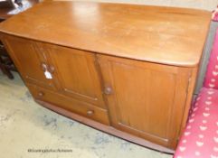 An Ercol Windsor elm three door sideboard W-114, D-51, H-81cm.