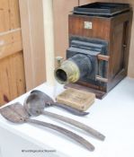 A Newton & Co Magic Lantern with slides and a group of three coconut domestic ladles
