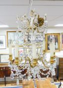 A gilt metal mounted and crystal eight branch chandelier