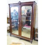 An early 20th century continental mirrored mahogany wardrobe. W-160, D-55, H-219cm.