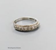 A modern 18ct white gold and eleven stone diamond chip set half eternity ring, size M, gross 2.8