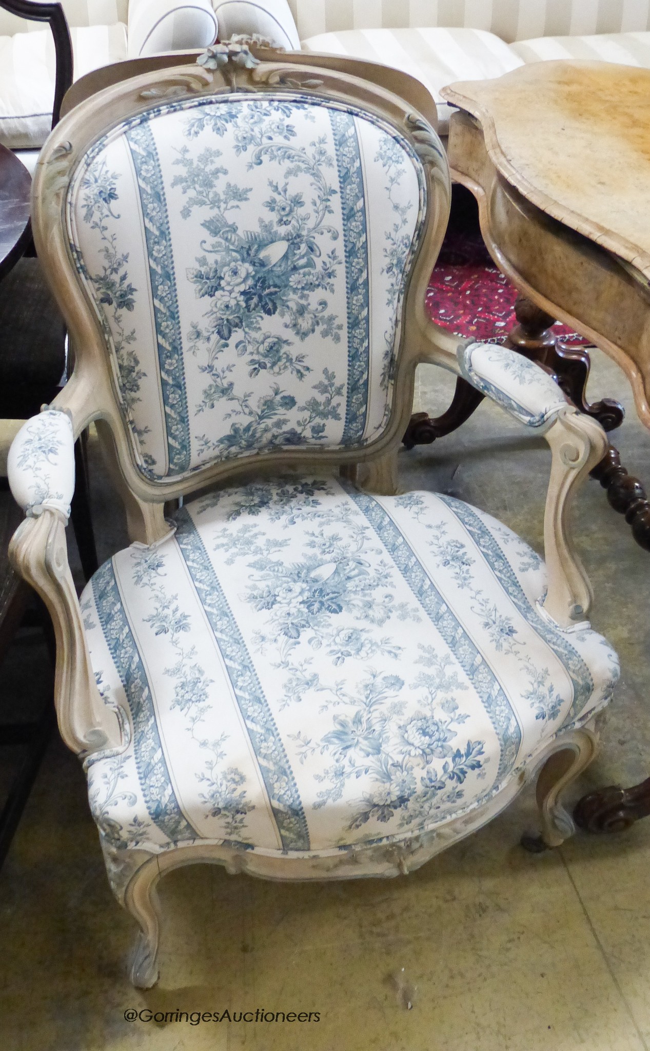 A pair of Louis XVI style upholstered elbow chairs.