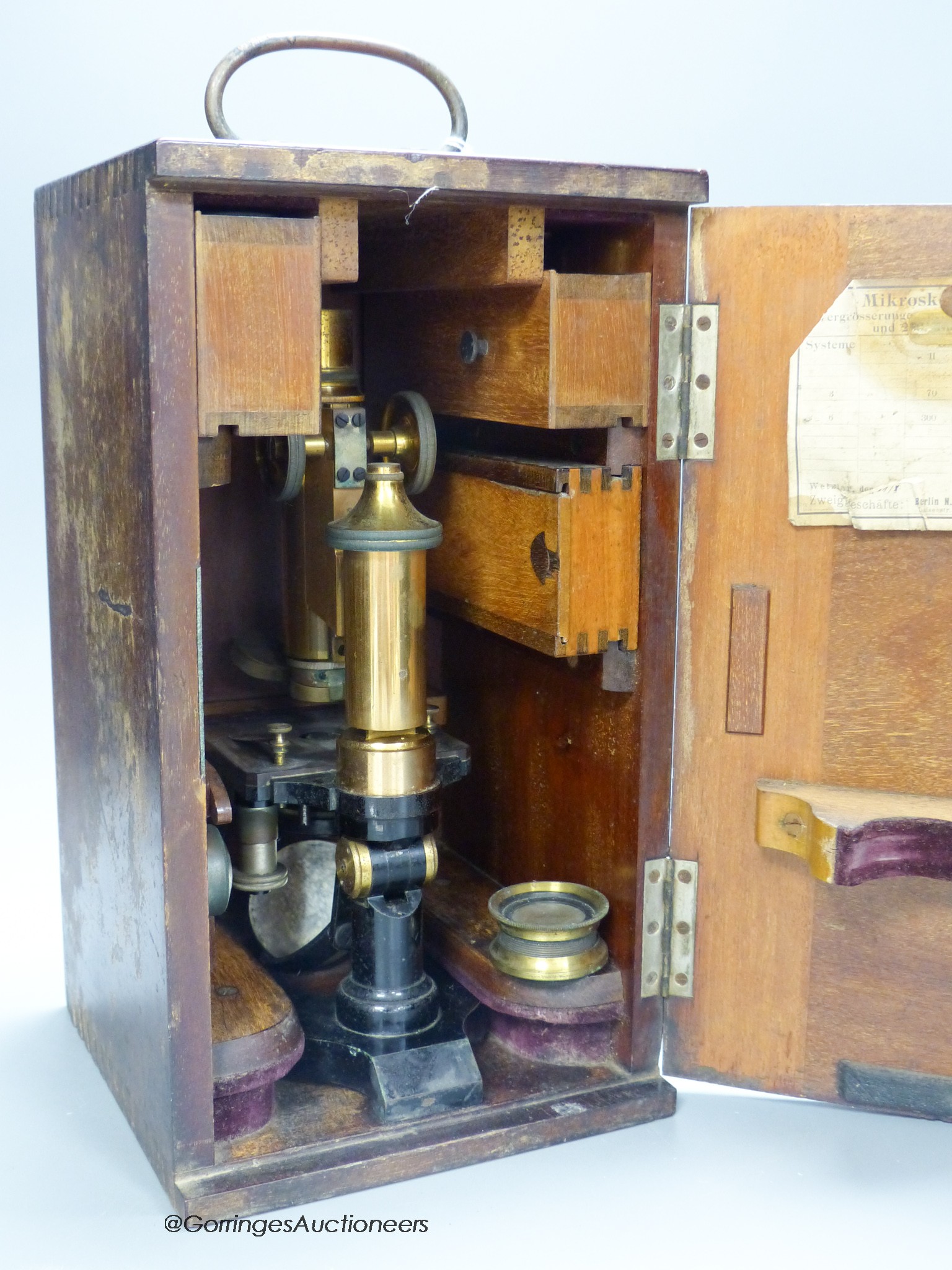 A lacquered brass microscope with lenses by E. Leitz, boxed