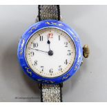 A lady's early 20th century silver and enamelled manual wind wrist watch, on a fabric strap.