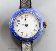 A lady's early 20th century silver and enamelled manual wind wrist watch, on a fabric strap.