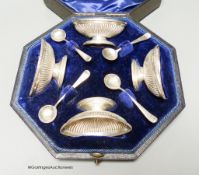 A cased set of four late Victorian fluted oval silver salts and four matching spoons, Elkington &