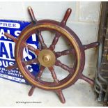 An early 20th century brass mounted mahogany ship's wheel. D-90cm.