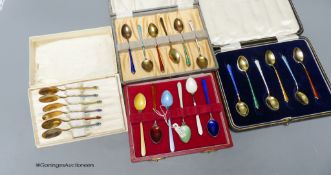 Four assorted cased sets of 6 sterling and enamel coffee spoons.
