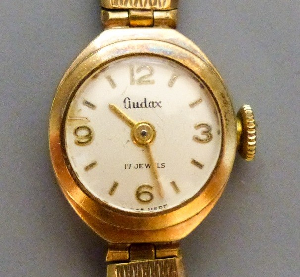 A lady's Audax 9ct gold manual wind wrist watch, on a 9ct gold bracelet,gross 18.2 grams, in Audax
