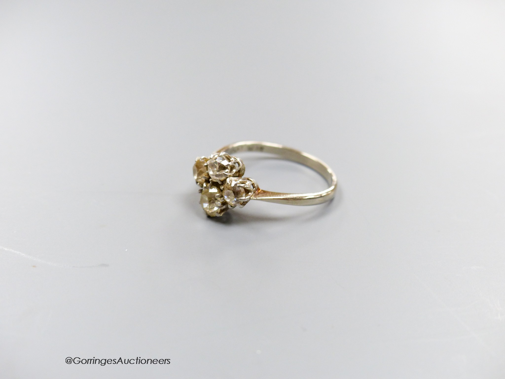 A white metal (stamped plat) and four stone diamond cluster ring, size O/P, gross 3.3 grams. - Image 2 of 4