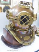 A copper and brass full size model of a diver's helmet, mounted as a lamp, height 46cm