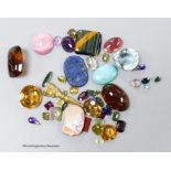 A small collection of unmounted mixed gemstones including citrine and amethyst and an intaglio