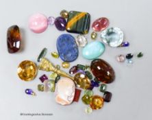 A small collection of unmounted mixed gemstones including citrine and amethyst and an intaglio