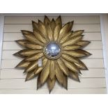 A contemporary gilt metal sunflower convex wall mirror. D-86cm.