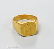 An 18c yellow metal signet ring, with engraved monogram, size S/T, 14.7 grams.