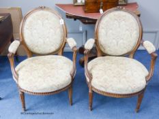 A pair of late 19th century french beech open armchairs.