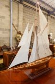 A large single masted model yacht on stand. H-160cm