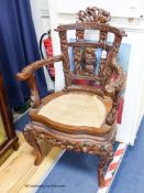 A Chinese carved elbow chair