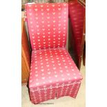 A side chair upholstered in bee patterned crimson fabric.