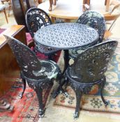 A tilt-top cast metal garden table and four chairs. Table, D-67, H-72cm.