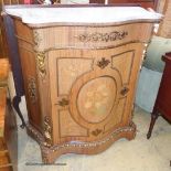 A Louis XV style marquetry inlaid, gilt metal mounted serpentine pier cabinet with white marble