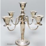 A white metal (stamped sterling) four branch, five light candelabrum, height 30.4cm, gross weight