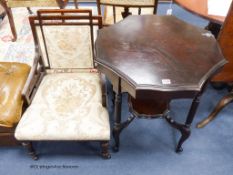 A late Victorian mahogany occasional table and similar nursing elbow chair