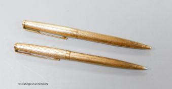 Two 9ct gold cased Parker pens.