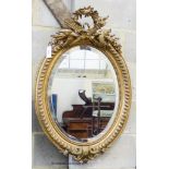 A late Victorian, gilt wood and gesso oval wall mirror, with bird pediment, W-63, H-96cm.