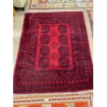 An Afghan red ground rug. 200x158cm.