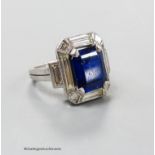 A white metal (stamped plat? synthetic sapphire, baguette and trapeze cut diamond set dress ring,