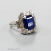 A white metal (stamped plat? synthetic sapphire, baguette and trapeze cut diamond set dress ring,
