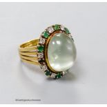 A modern 750 yellow metal, pale green cabochon stone, emerald and diamond set oval dress ring, size