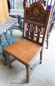 An Arts and Crafts oak and embossed copper hall chair.