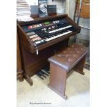 A Hammond organ, XT-100/XH-200 with stool and a quantity of music books. W-125cm.