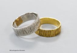 A modern textured 18ct gold band, size S, 5 grams and a similar 9ct white gold band, size S, 4.7