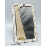 An Edwardian repousse silver mounted rectangular easel mirror, Deakin & Francis, Birmingham, 1904,