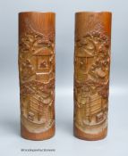 A pair of Chinese bamboo brush pots, carved with scholars in gardens, height 36cm