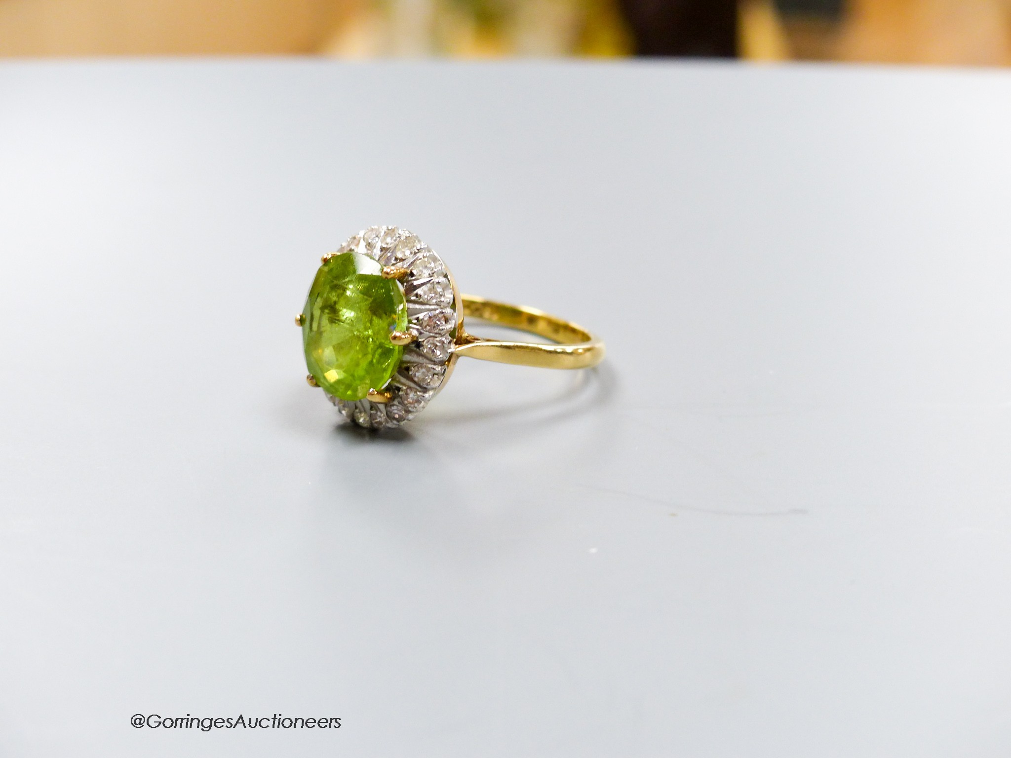 An 18ct, peridot and diamond oval cluster set dress ring, size T, gross 7 grams. - Image 2 of 2