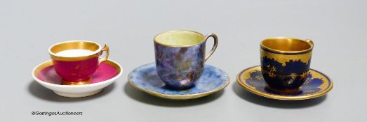 A Wedgwood lustre miniature cup and saucer with gilt decoration, a Coalport blue and raised gilt