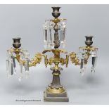 A 19th-century French bronze and ormolu three light candelabrum, 39cm high