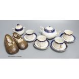 A child's tea set and a pair of leather shoes