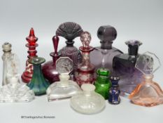 A collection of 1920's and earlier glass scent bottles to include ruby, amethyst, blue, clear and