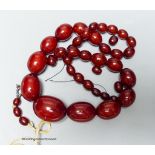 A single strand graduated simulated cherry amber necklace (a.f.) gross 56 grams.