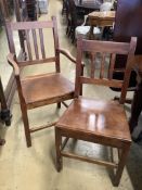 A set of six 19th century provincial fruitwood solid seat dining chairs, one with arms.