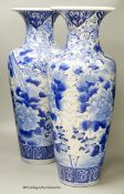 A pair of large Japanese blue and white vases (one a.f.), 60cm high