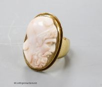 An antique yellow metal and oval cameo quartz? ring, carved with head of a gentlemen to sinister,